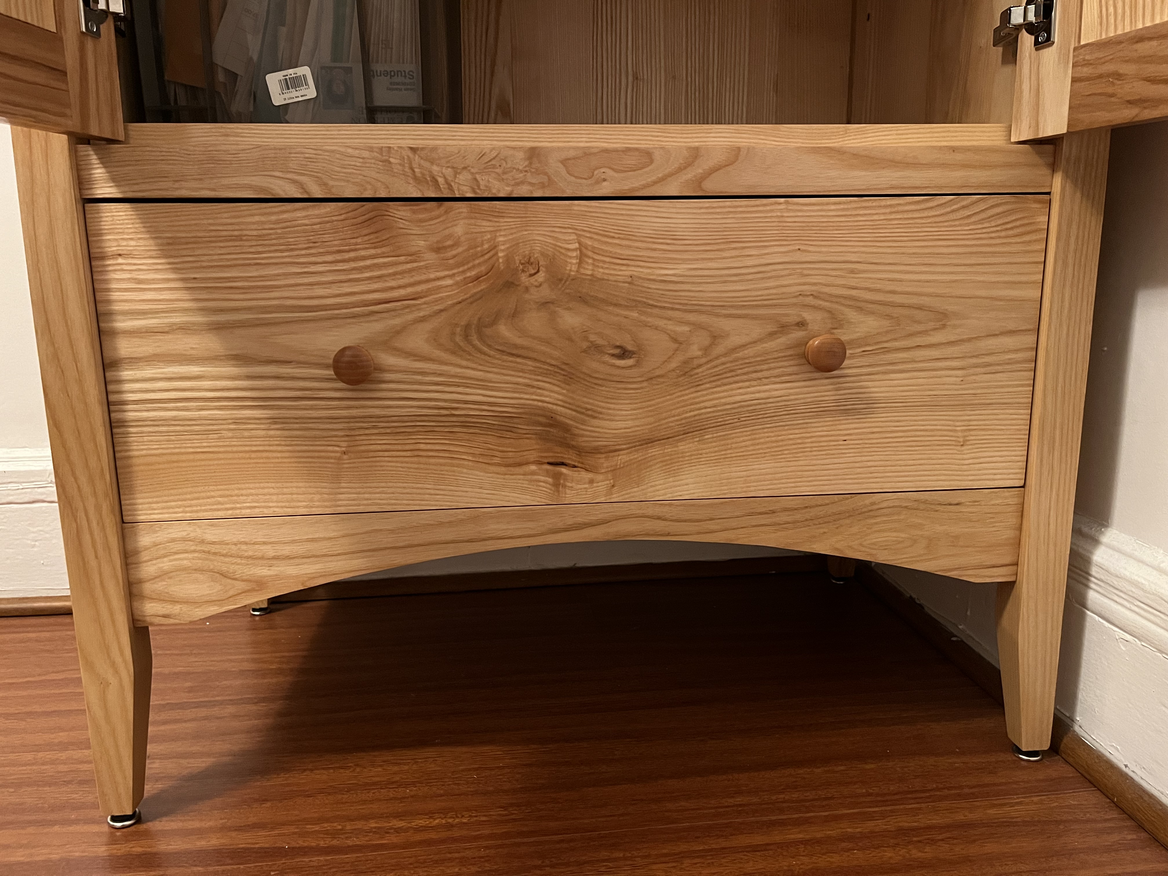 A shaker-style armoire made of ash, close-up of drawer