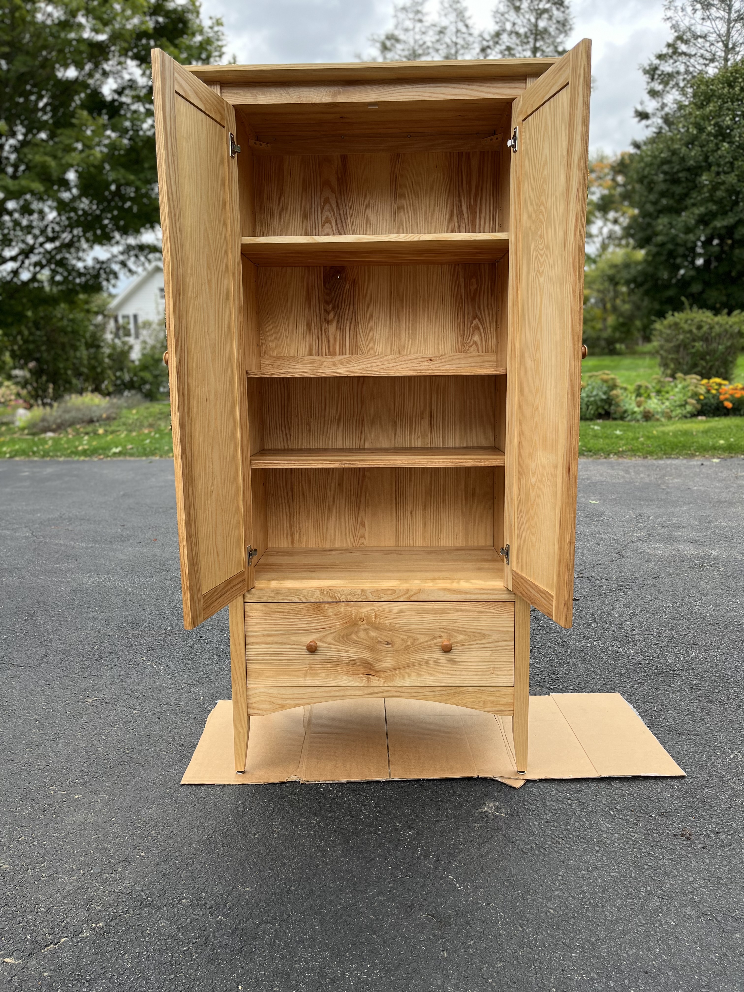 A shaker-style armoire made of ash