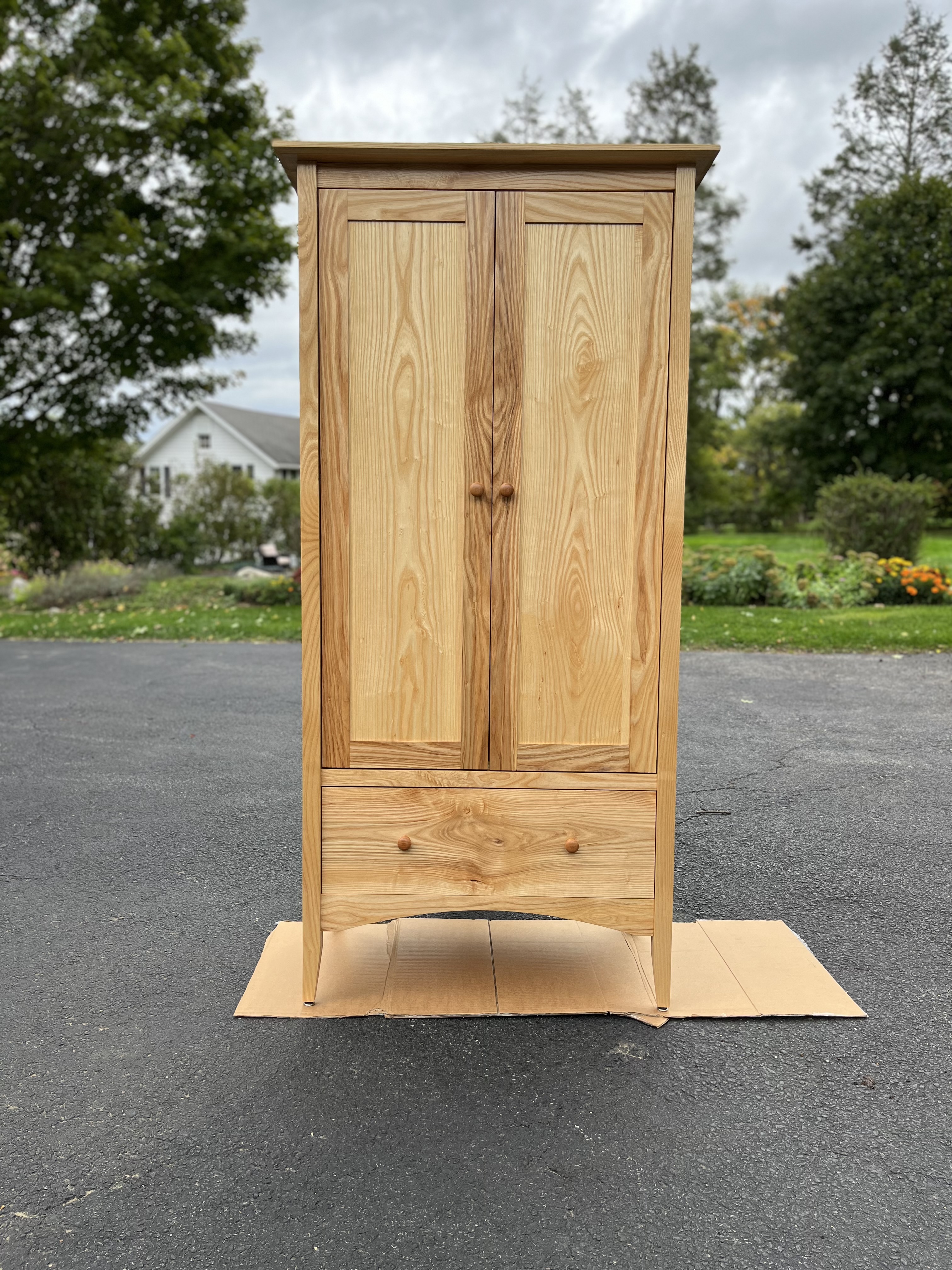 A shaker-style armoire made of ash